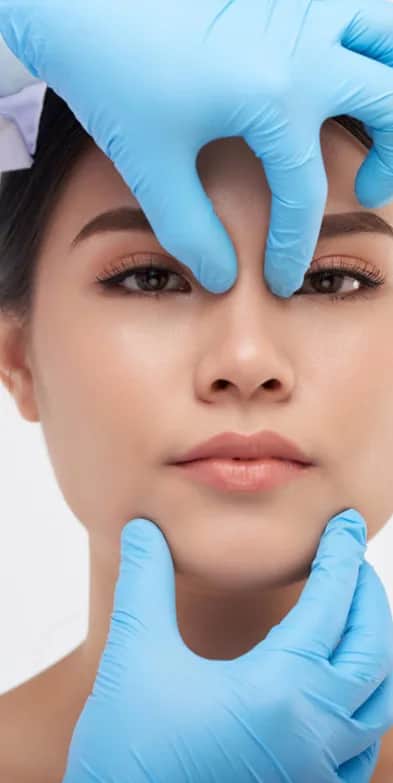 Alarplasty: Asian Woman having her nose analyzed by a doctor