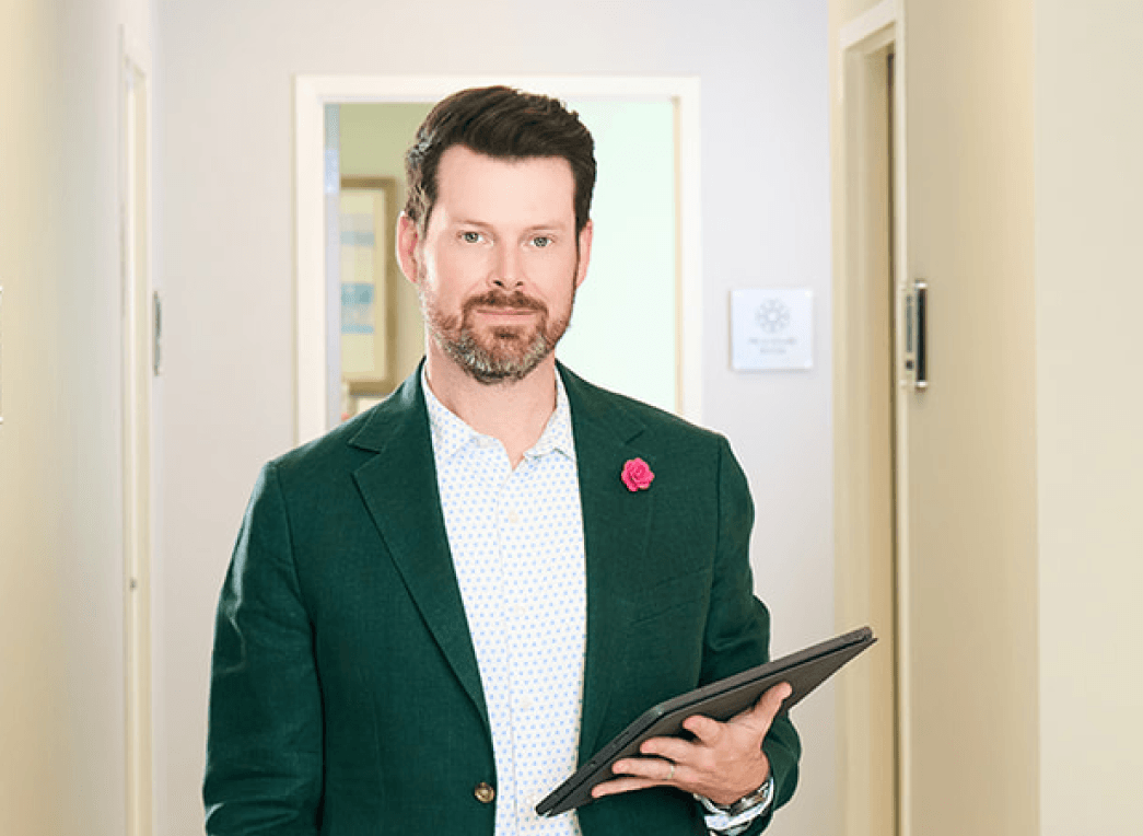 Dr. Bader holding a tablet in the office