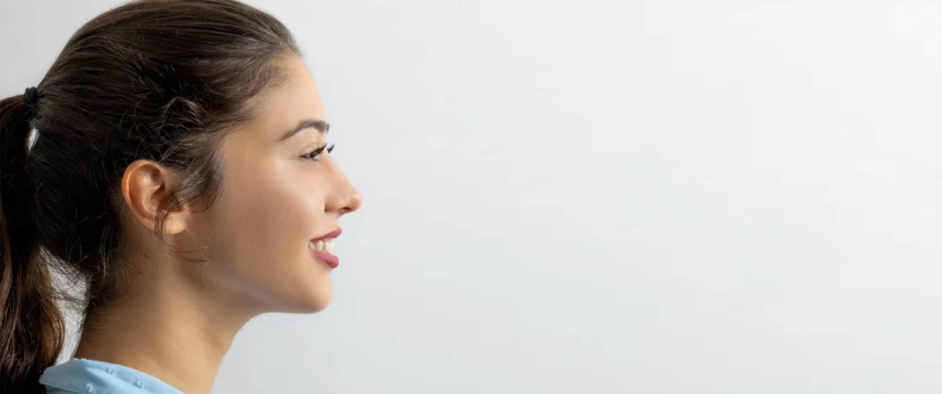 Septoplasty Dallas: Side profile of a young woman smiling