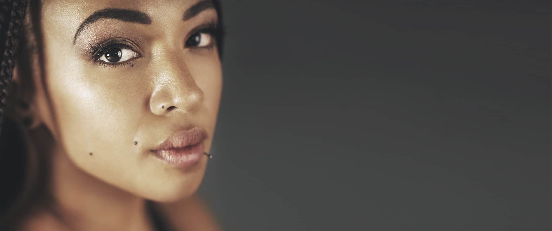 Ethnic rhinoplasty: Close-up portrait of a woman with natural features and defined nasal profile