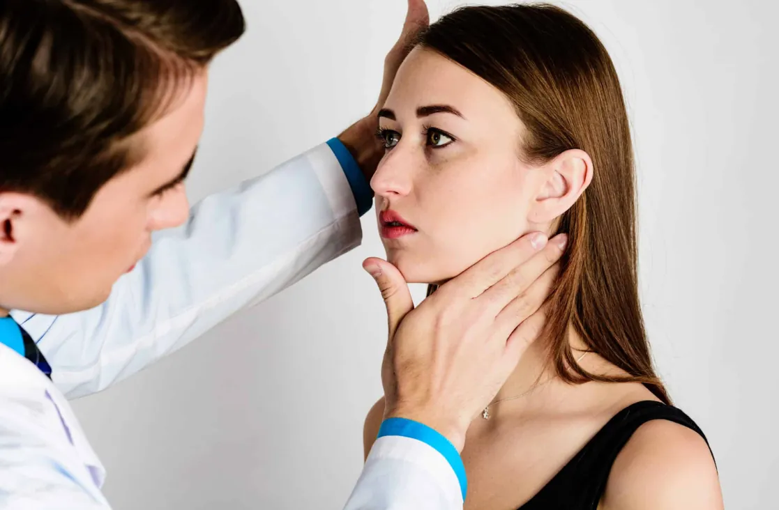 Alarplasty: woman being examined by doctor