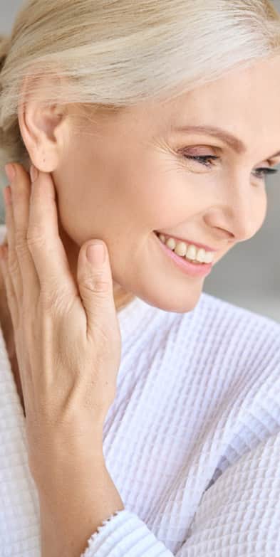 Facial Scar Treatment: Older woman smiling while looking down