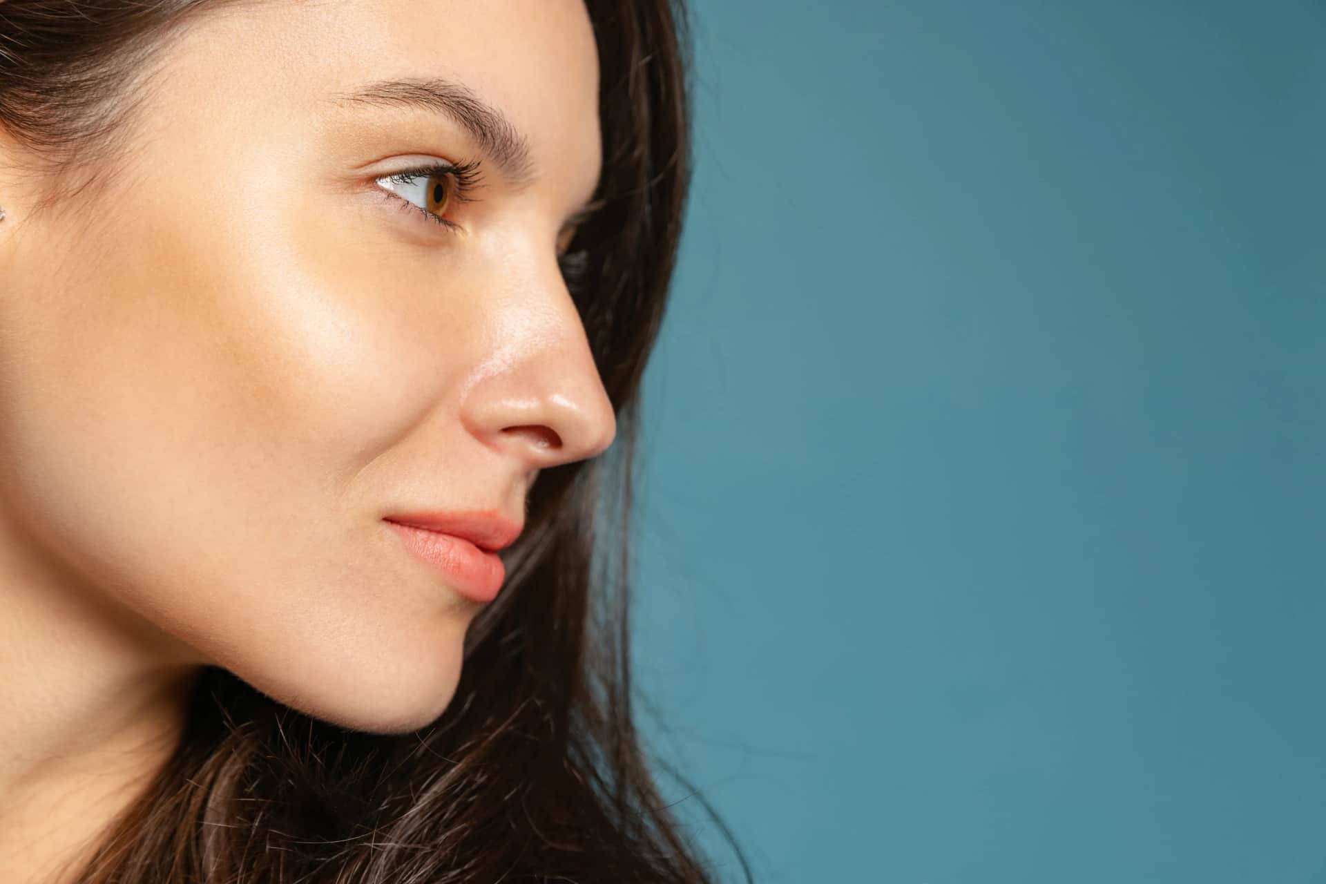 Nasal Reconstruction: A close-up of a woman’s profile showing her nose, highlighting the natural contours and features post-nasal reconstruction.