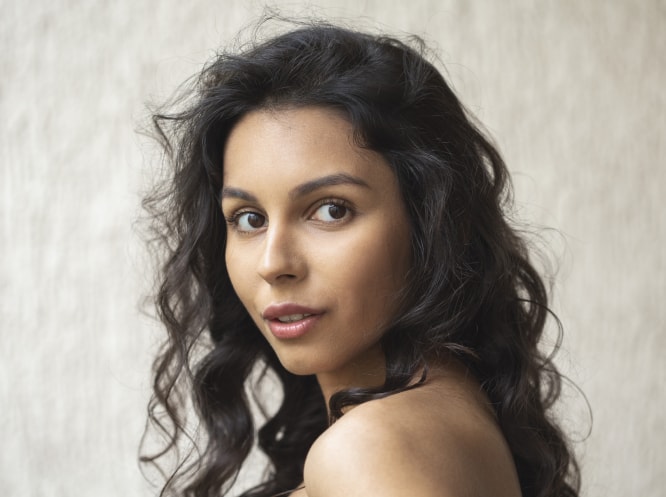 Woman with natural facial profile representing candidacy for deviated septum surgery consultation in Plano and Dallas