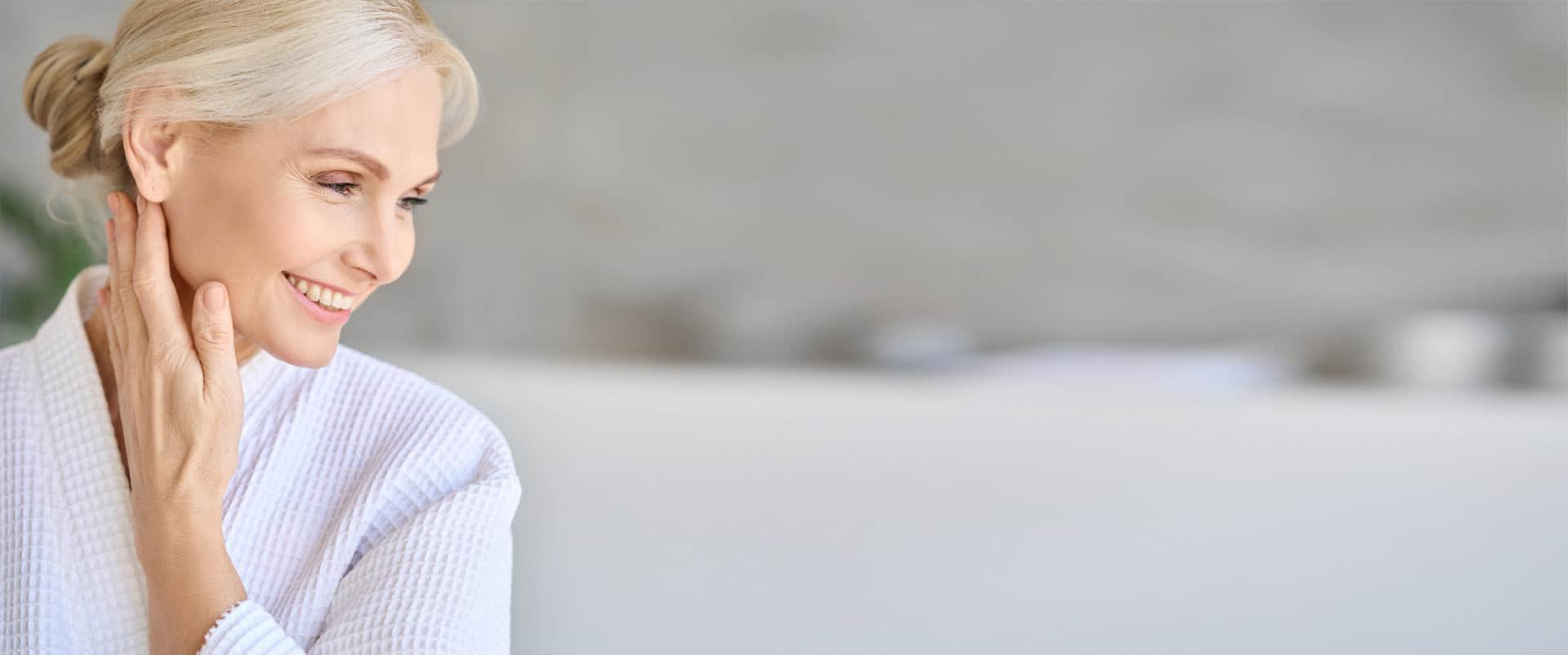 Facial Scar Treatment: Older woman smiling while looking down