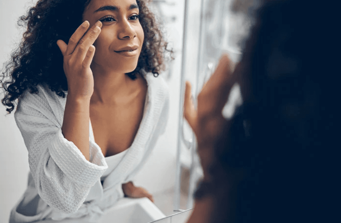 Liquid Facelift: Woman looking at herself in the mirror
