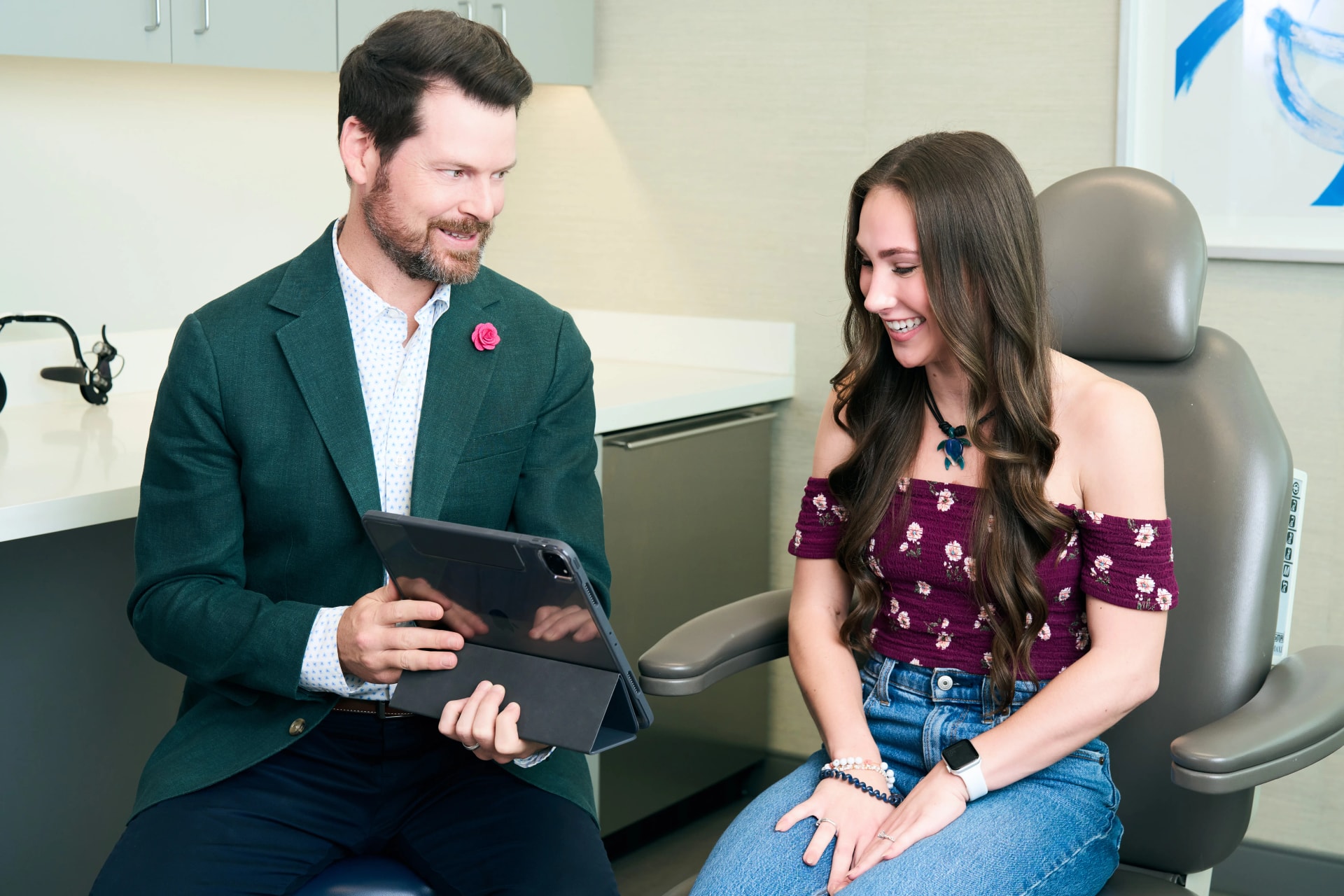 Facial Scar Treatment: Dr. Bader showing results to his patient on his tablet