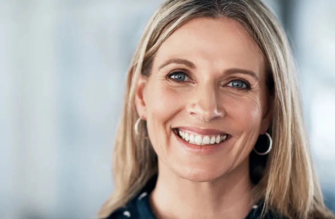 Septoplasty Surgery Dallas: Older blonde woman smiling at the camera